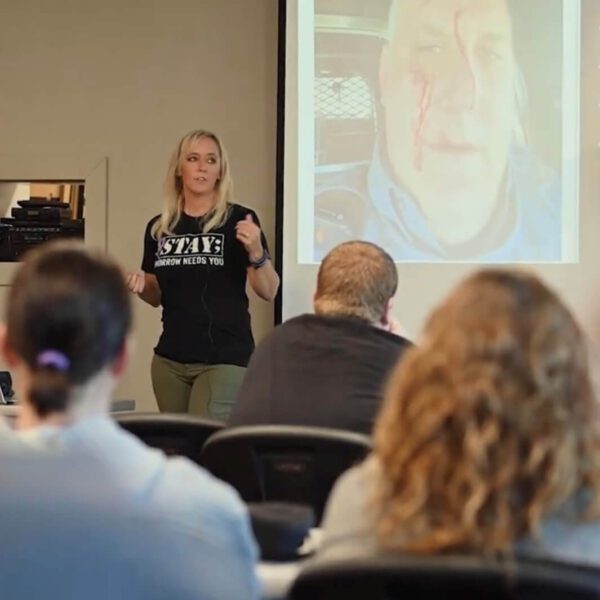 Christi presenting in front of a crowd